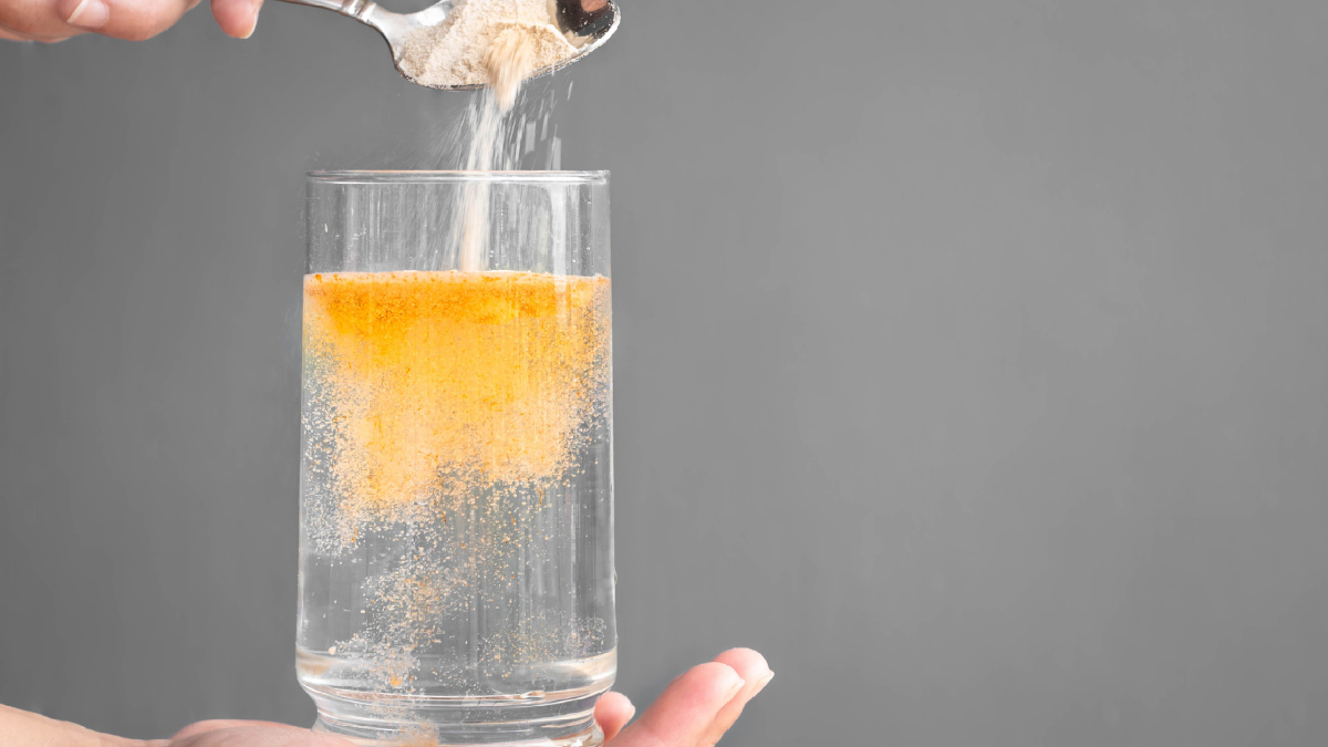 glass of water with a powdered supplement