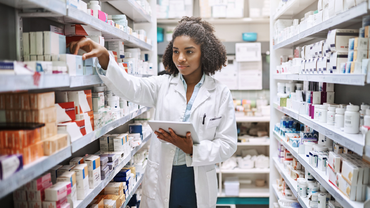 pharmacist taking medicine off the shelf